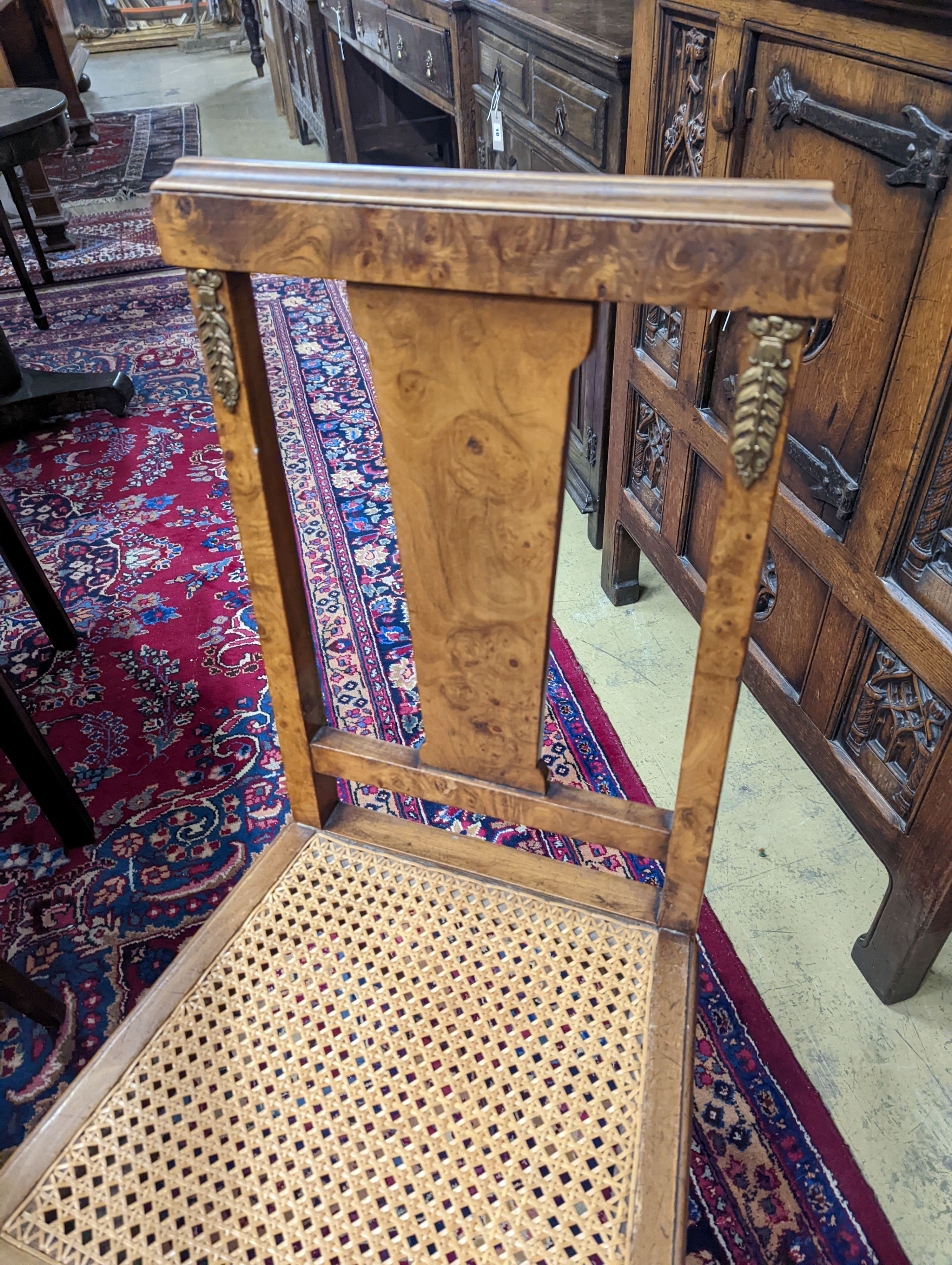 A set of six early 20th century French walnut and gilt metal mounted chairs. 50-70